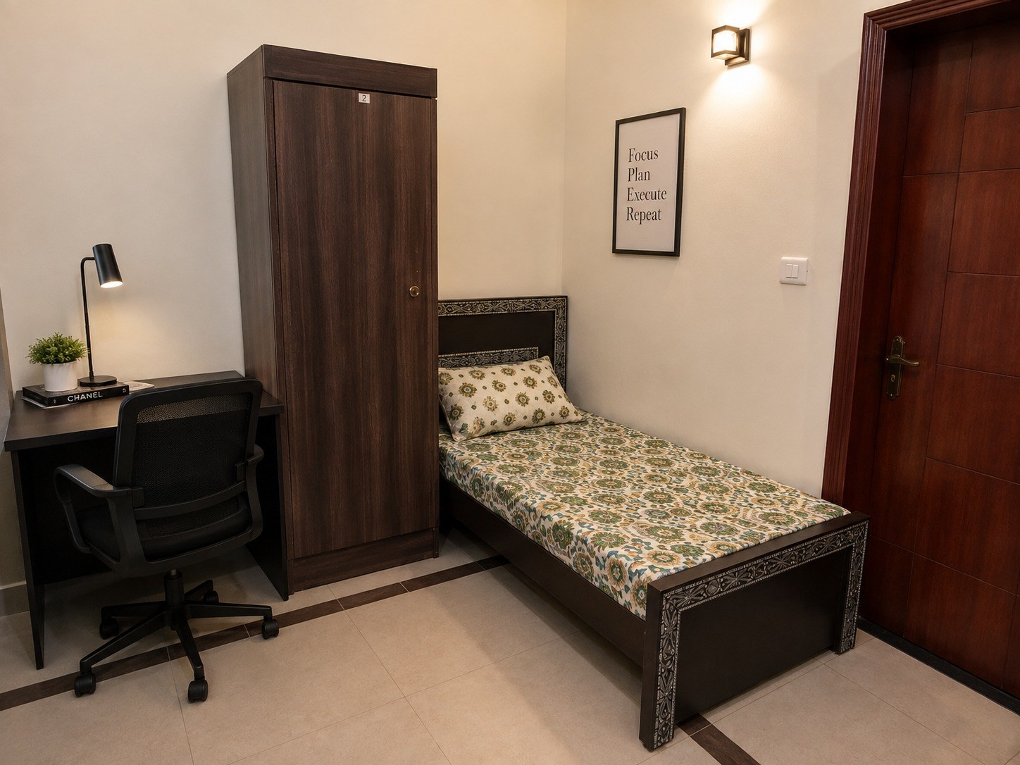 A furnished room inside Nazzal Accommodation Services hostel, with bed, study desk and wardrobe