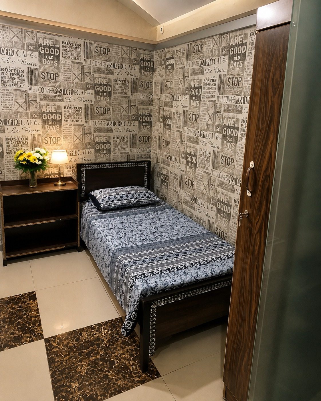 Cozy single room with patterned wallpaper